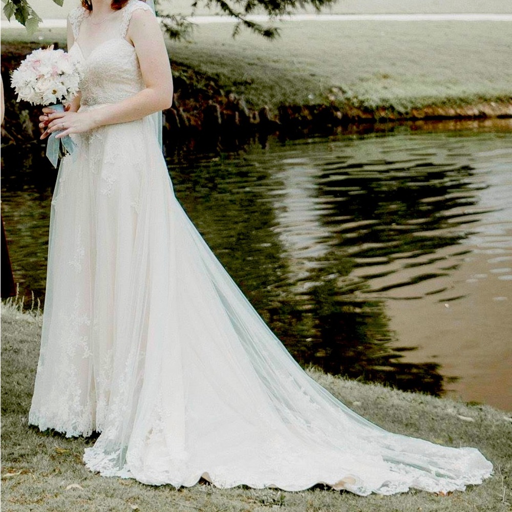 Lightly used wedding gown. It’s been altered with bustling and comes with a belt